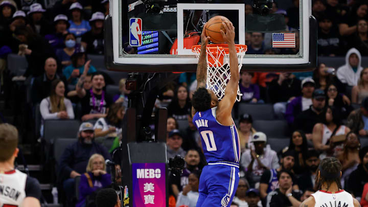 Feb 26, 2024; Sacramento, California, USA; Sacramento Kings guard Malik Monk (0) dunks the ball against Miami Heat forward Haywood Highsmith (24) during the second quarter at Golden 1 Center. Mandatory Credit: Sergio Estrada-Imagn Images
