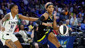 Jun 8, 2025; Arlington, Texas, USA; Dallas Wings guard DiJonai Carrington (21) drives to the basket ahead of Minnesota Lynx guard Courtney Williams (10) during the first half at College Park Center. Mandatory Credit: Chris Jones-Imagn Images