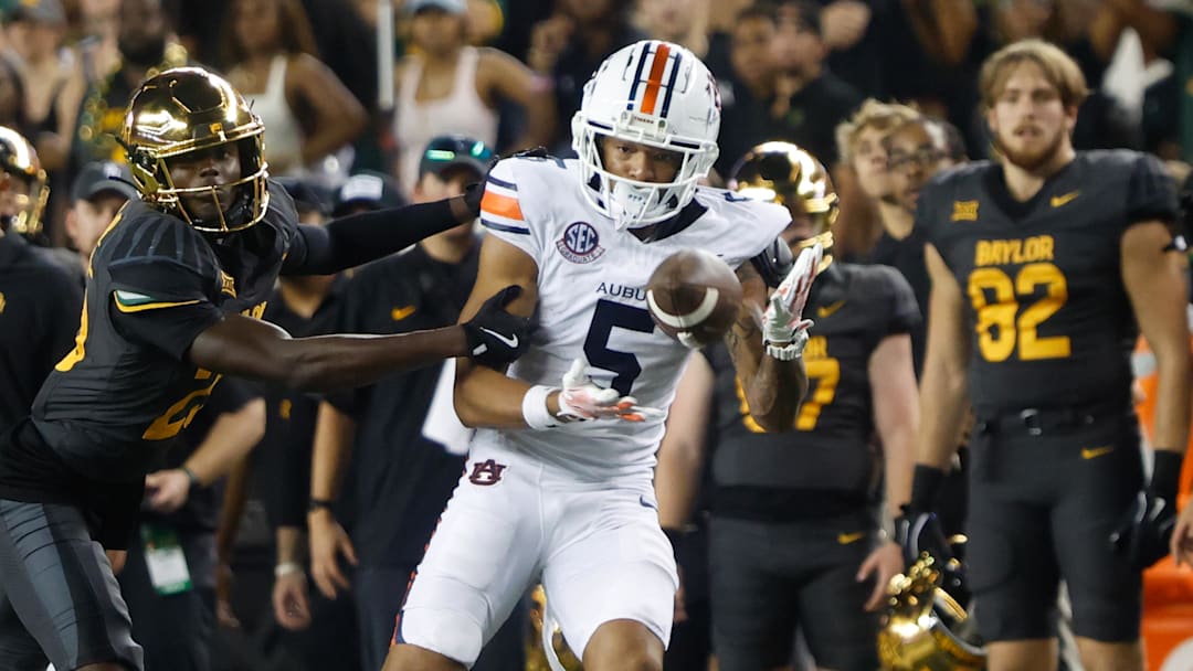 Aug 29, 2025; Waco, Texas, USA;  Auburn Tigers wide receiver Horatio Fields (5) catchesa pass against Baylor Bears safety Cameren Jenkins (23) during the second half at McLane Stadium. Mandatory Credit: Chris Jones-Imagn Images