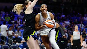 Jul 27, 2025; Arlington, Texas; Las Vegas Aces center A'ja Wilson (22) drives to the basket against Dallas Wings center Luisa Geiselsoder (18) during the first half at College Park Center. 