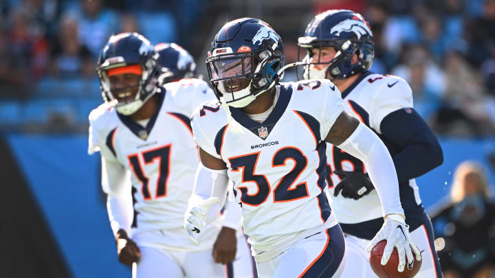 Nov 27, 2022; Charlotte, North Carolina, USA;  Denver Broncos safety Delarrin Turner-Yell (32) reacts after recovering a fumble in the second quarter at Bank of America Stadium. 