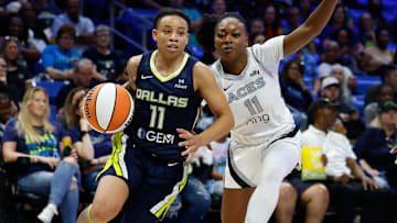 Jul 16, 2025; Arlington, Texas, USA;  Dallas Wings guard JJ Quinerly (11) drives to the basket against Las Vegas Aces guard Dana Evans (11) during the second half at College Park Center. Mandatory Credit: Chris Jones-Imagn Images