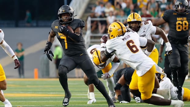 Baylor Bears running back Bryson Washington (7) carries the ball as Arizona State Sun Devils safety Adrian Wilson (6) defends