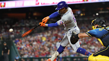 Sep 13, 2024; Philadelphia, Pennsylvania, USA; New York Mets shortstop Francisco Lindor (12) hits a single during the fifth inning against the Philadelphia Phillies at Citizens Bank Park. Mandatory Credit: Bill Streicher-Imagn Images