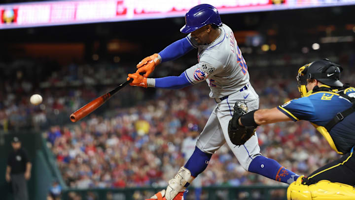 Sep 13, 2024; Philadelphia, Pennsylvania, USA; New York Mets shortstop Francisco Lindor (12) hits a single during the fifth inning against the Philadelphia Phillies at Citizens Bank Park. Mandatory Credit: Bill Streicher-Imagn Images