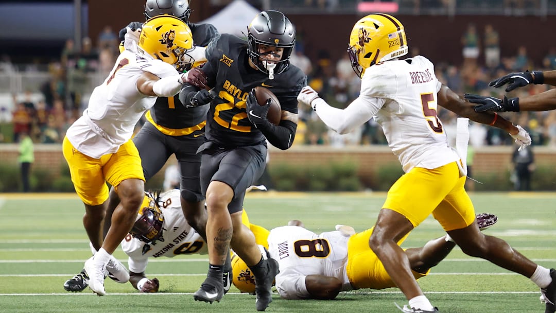 Sep 20, 2025; Waco, Texas, USA; Baylor Bears running back Caden Knighten (22) carries the ball against Arizona State Sun Devils safety Kyndrich Breedlove (5) during the first half at McLane Stadium. Mandatory Credit: Chris Jones-Imagn Images
