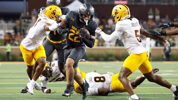 Sep 20, 2025; Waco, Texas, USA; Baylor Bears running back Caden Knighten (22) carries the ball against Arizona State Sun Devils safety Kyndrich Breedlove (5) during the first half at McLane Stadium. Mandatory Credit: Chris Jones-Imagn Images