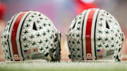 Jan 1, 2016; Glendale, AZ, USA; Two Ohio State Buckeyes helmets sit on the field during warmups before the 2016 Fiesta Bowl between the Notre Dame Fighting Irish and the Ohio State Buckeyesat University of Phoenix Stadium. Mandatory Credit: Matt Cashore-Imagn Images