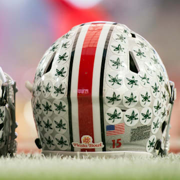 Jan 1, 2016; Glendale, AZ, USA; Two Ohio State Buckeyes helmets sit on the field during warmups before the 2016 Fiesta Bowl between the Notre Dame Fighting Irish and the Ohio State Buckeyesat University of Phoenix Stadium. Mandatory Credit: Matt Cashore-Imagn Images
