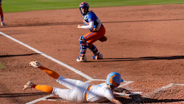 Tennessee's Laura Mealer (2) slides in to home at Florida's Jocelyn Erickson (8) looks on in the first inning of the Women's College World Series softball game between the Florida Gators and the Tennessee Volunteers at Devon Park in Oklahoma City, Friday, May, 30, 2025.