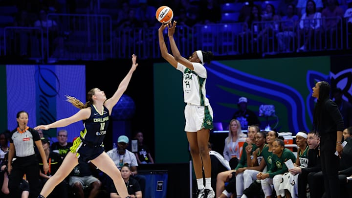 Aug 22, 2025; Arlington, Texas, USA;  Seattle Storm center Dominique Malonga (14) scores a three-point basket against Dallas Wings center Luisa Geiselsoder (18) during the second half at College Park Center. Mandatory Credit: Chris Jones-Imagn Images