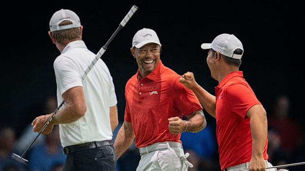 Tiger Woods and Tom Kim of Jupiter Links GC celebrate against Atlanta Drive GC during a TGL match in March 2025.