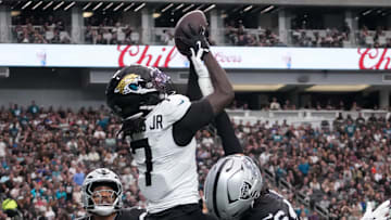 Nov 2, 2025; Paradise, Nevada, USA;  Jacksonville Jaguars wide receiver Brian Thomas Jr. (7) attempts to catch the ball against Las Vegas Raiders safety Isaiah Pola-Mao (20) and cornerback Darien Porter (26) in the first half at Allegiant Stadium. Mandatory Credit: Kirby Lee-Imagn Images