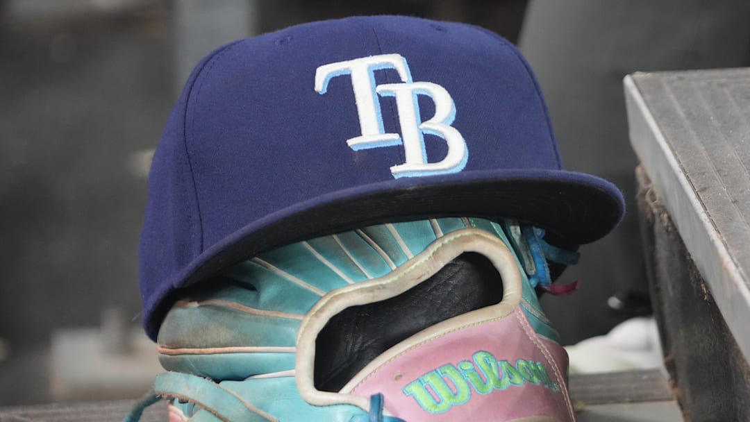 Sep 26, 2025; Toronto, Ontario, CAN; The hat and glove of Tampa Bay Rays third baseman Junior Caminero (13) in the dugout during the game against the Toronto Blue Jays at Rogers Centre. 