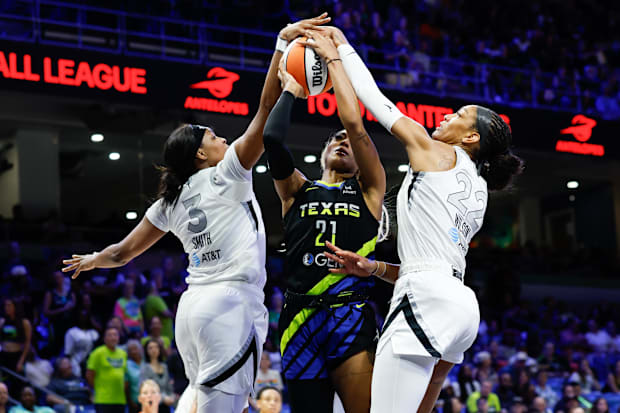 Dallas Wings guard DiJonai Carrington has her shot blocked by Las Vegas Aces forward NaLyssa Smith. 