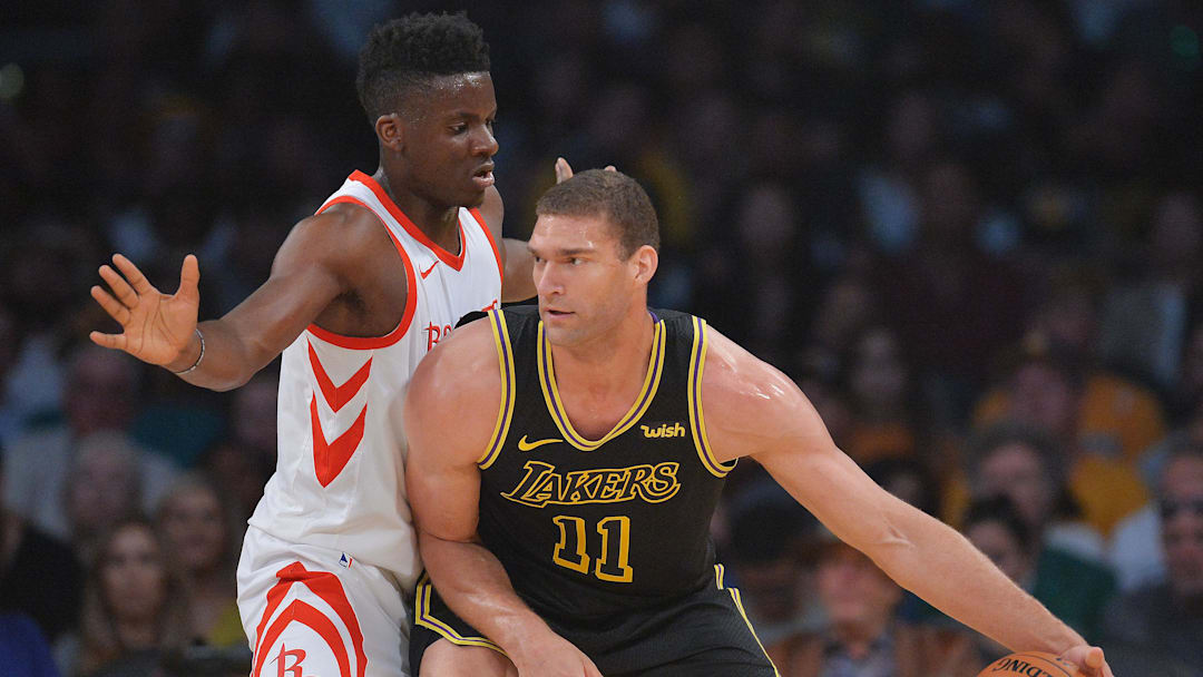 April 10, 2018; Los Angeles, CA, USA; Los Angeles Lakers center Brook Lopez (11) moves the ball against Houston Rockets center Clint Capela (15) during the first half  at Staples Center.