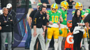 Jan 1, 2024; Glendale, AZ, USA; Oregon Ducks quarterback Bo Nix (10) talks to head coach Dan Lanning on the sideline during the second half against the Liberty Flames in the 2024 Fiesta Bowl at State Farm Stadium. Mandatory Credit: Joe Camporeale-USA TODAY Sports
