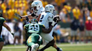 Sep 13, 2025; Waco, Texas, USA;  Samford Bulldogs quarterback Quincy Crittendon (2) is tackled by Baylor Bears defensive lineman Devonte Tezino (59) for a short gain during the first half at McLane Stadium. Mandatory Credit: Chris Jones-Imagn Images
