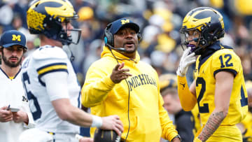 Michigan offensive pass game coordinator and wide receivers coach Ron Bellamy talks to quarterback Davis Warren (16) during the second half of the spring game at Michigan Stadium in Ann Arbor on Saturday, April 20, 2024.