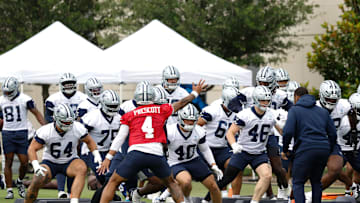 Jun 10, 2025; Arlington, TX, USA;  Dallas Cowboys quarterback Dak Prescott (4) leads teammates through a drill at the Ford Center at the Star Training Facility in Frisco, Texas. Mandatory Credit: Chris Jones-Imagn Images