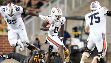 Aug 29, 2025; Waco, Texas, USA;  Auburn Tigers running back Damari Alston (0) runs the ball against Baylor Bears defensive lineman Devonte Tezino (59) during the first half at McLane Stadium. Mandatory Credit: Chris Jones-Imagn Images