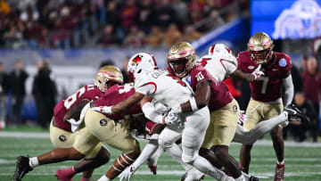 Dec 2, 2023; Charlotte, NC, USA; Louisville Cardinals wide receiver Kevin Coleman (3) is tackled by Florida State Seminoles linebacker DJ Lundy (10) in the first quarter at Bank of America Stadium. Mandatory Credit: Bob Donnan-USA TODAY Sports