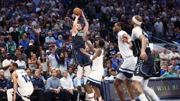 Dallas Mavericks guard Luka Doncic (77) shoots over Minnesota Timberwolves guard Anthony Edwards (5) during the fourth quarter of Game 4 of the Western Conference finals at American Airlines Center in Dallas on May 28, 2024. 