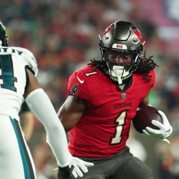 Jan 15, 2024; Tampa, Florida, USA; Tampa Bay Buccaneers running back Rachaad White (1) runs the ball as Philadelphia Eagles cornerback James Bradberry (24) defends during the first half of a 2024 NFC wild card game at Raymond James Stadium. Mandatory Credit: Kim Klement Neitzel-USA TODAY Sports