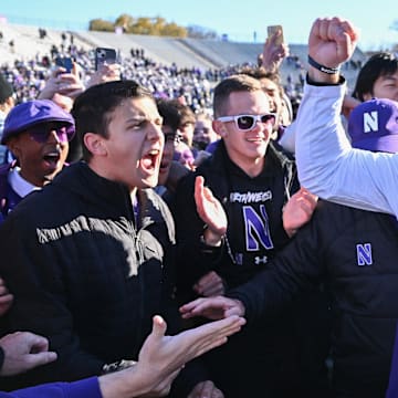 Nov 18, 2023; Evanston, Illinois, USA;  Northwestern Wildcats head coach David Braun celebrates with fans after defeating the Purdue Boilermakers 23-15 at Ryan Field. Mandatory Credit: Jamie Sabau-Imagn Images