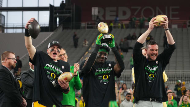 Jan 1, 2024; Glendale, AZ, USA; Oregon Ducks quarterback Bo Nix (10), linebacker Jeffrey Bassa (2) and  head coach Dan Lannin