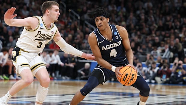 Utah State Aggies guard Ian Martinez (4) evades Purdue Boilermakers guard Braden Smith (3) during the first half