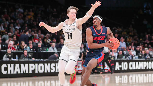 Shulga defends against Duquesne guard Jimmy Clark III.