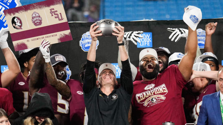 Dec 2, 2023; Charlotte, NC, USA; Florida State Seminoles head coach Mike Norvell raises the ACC Championship trophy with his players after the game against the Louisville Cardinals at Bank of America Stadium. Mandatory Credit: Jim Dedmon-USA TODAY Sports