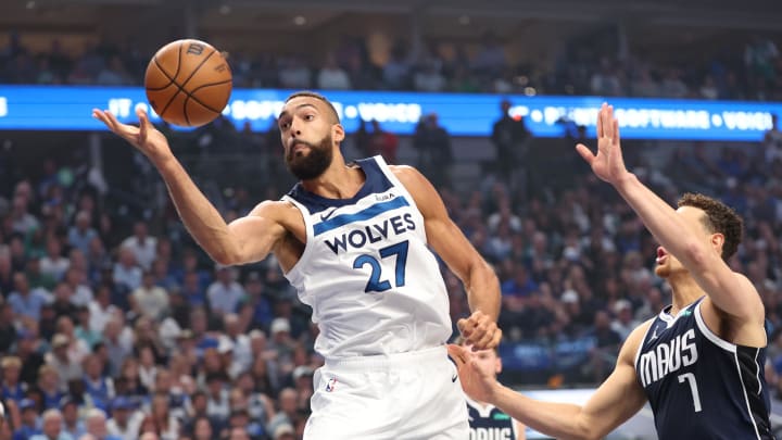 Minnesota Timberwolves center Rudy Gobert (27) controls the ball as Dallas Mavericks center Dwight Powell (7) defends during the first quarter of Game 4 of the Western Conference finals at American Airlines Center in Dallas on May 28, 2024. 