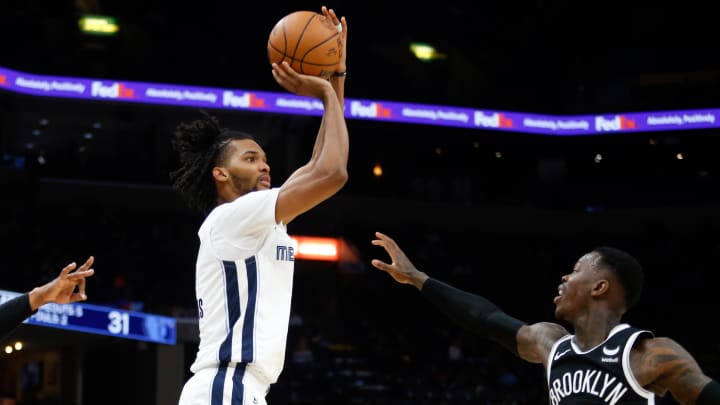 Feb 26, 2024; Memphis, Tennessee, USA; Memphis Grizzlies forward Ziaire Williams (8) shoots from the three point line as Brooklyn Nets guard Dennis Schroder (17) defends during the first half at FedExForum. Mandatory Credit: Petre Thomas-USA TODAY Sports