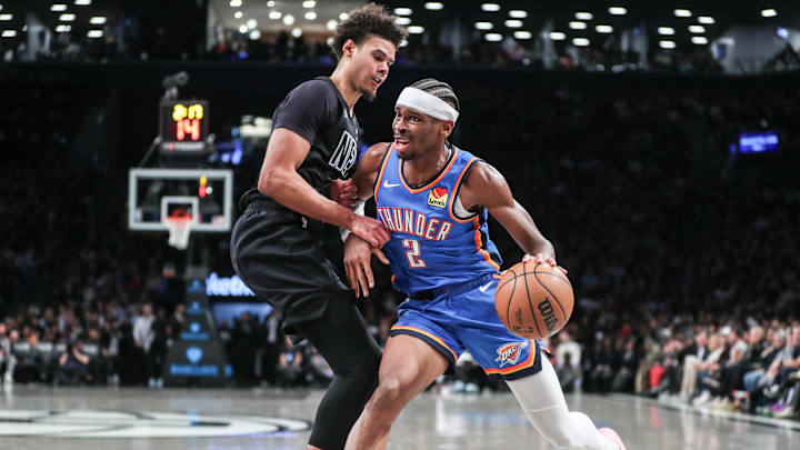 Jan 5, 2024; Brooklyn, New York, USA;  Oklahoma City Thunder guard Shai Gilgeous-Alexander (2) dribbles against Brooklyn Nets forward Cameron Johnson (2) in the third quarter at Barclays Center. Mandatory Credit: Wendell Cruz-Imagn Images