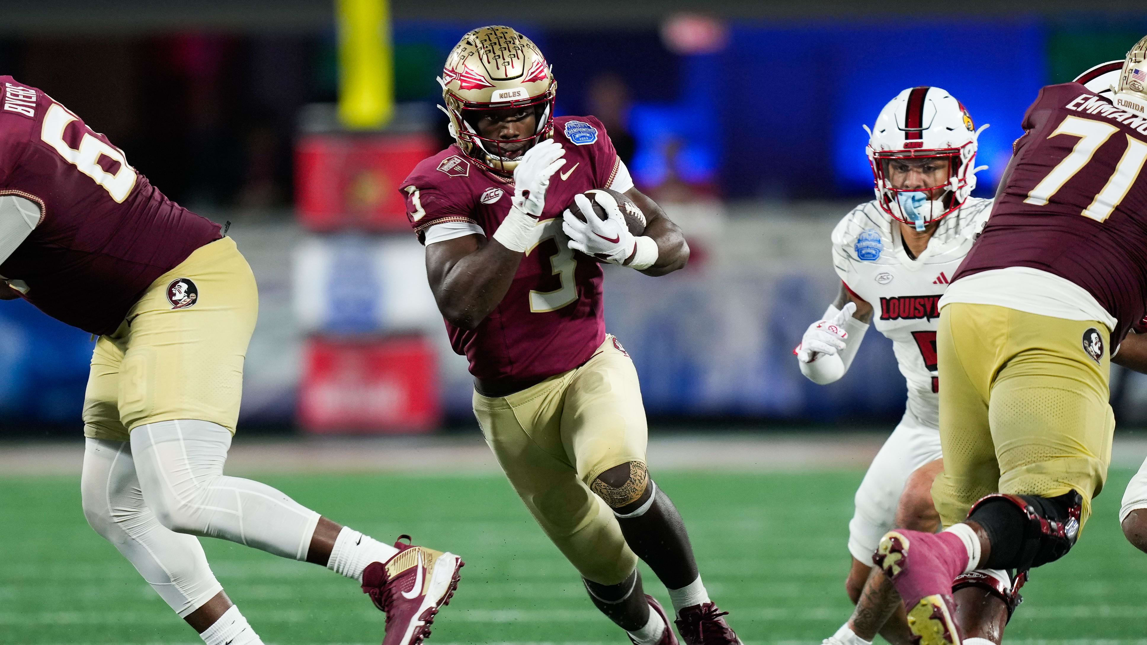 Florida State Seminoles running back Trey Benson (3) runs the ball.