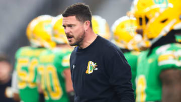 Jan 1, 2024; Glendale, AZ, USA; Oregon Ducks head coach Dan Lanning watches from the sidelines during warm ups before the 2024 Fiesta Bowl against the Liberty Flames at State Farm Stadium. Mandatory Credit: Mark J. Rebilas-USA TODAY Sports