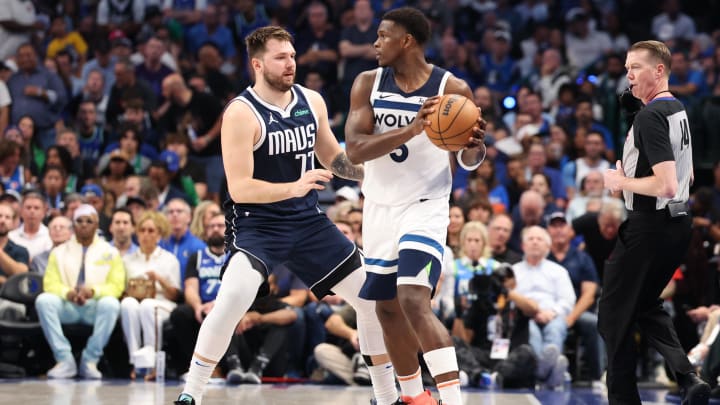 May 28, 2024; Dallas, Texas, USA; Minnesota Timberwolves guard Anthony Edwards (5) controls the ball against Dallas Mavericks guard Luka Doncic (77) during the third quarter of game four of the western conference finals for the 2024 NBA playoffs at American Airlines Center. Mandatory Credit: Kevin Jairaj-USA TODAY Sports