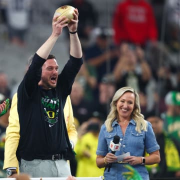 Jan 1, 2024; Glendale, AZ, USA; Oregon Ducks head coach Dan Lanning lifts the Fiesta Bowl trophy after a victory against the Liberty Flames in the 2024 Fiesta Bowl at State Farm Stadium. The Ducks won 45-6.