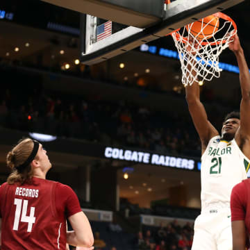 Mar 22, 2024; Memphis, TN, USA; Baylor Bears center Yves Missi (21) dunks the ball against the Colgate Raiders during the first half of the NCAA Tournament First Round at FedExForum. 