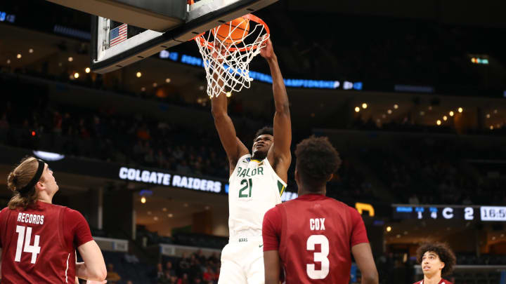 Mar 22, 2024; Memphis, TN, USA; Baylor Bears center Yves Missi (21) dunks the ball against the Colgate Raiders during the first half of the NCAA Tournament First Round at FedExForum. 