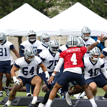 Dallas Cowboys quarterback Dak Prescott leads teammates through a drill at the Ford Center at the Star Training Facility.