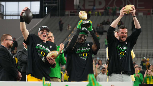 Jan 1, 2024; Glendale, AZ, USA; Oregon Ducks quarterback Bo Nix (10), linebacker Jeffrey Bassa (2) and coach Dan Lanning