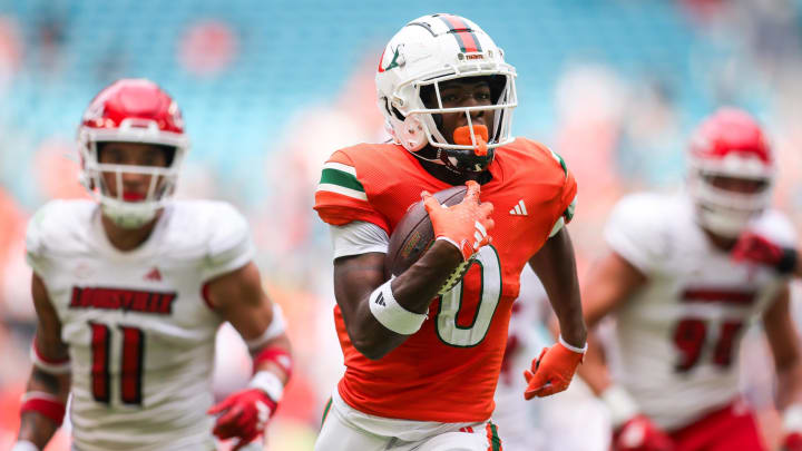 Nov 18, 2023; Miami Gardens, Florida, USA; Miami Hurricanes wide receiver Brashard Smith (0) runs with the football for a touchdown against the Louisville Cardinals during the second quarter at Hard Rock Stadium. Mandatory Credit: Sam Navarro-USA TODAY Sports