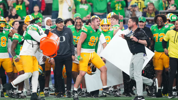 Jan 1, 2024; Glendale, AZ, USA; Oregon Ducks head coach Dan Lanning reacts after being doused in Gatorade at the end of the 2024 Fiesta Bowl against the Liberty Flames at State Farm Stadium. The Ducks won 45-6. Mandatory Credit: Joe Camporeale-USA TODAY Sports