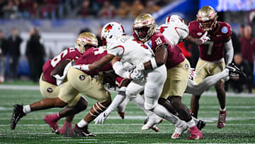 Dec 2, 2023; Charlotte, NC, USA; Louisville Cardinals wide receiver Kevin Coleman (3) is tackled by Florida State Seminoles linebacker DJ Lundy (10) in the first quarter at Bank of America Stadium. Mandatory Credit: Bob Donnan-Imagn Images