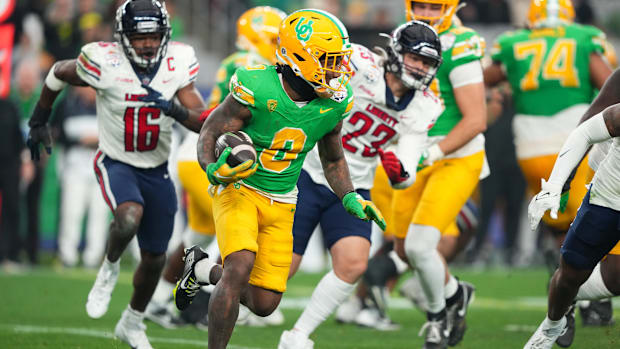 Jan 1, 2024; Glendale, AZ, USA; Oregon Ducks running back Bucky Irving (0) runs the ball against the Liberty Flames during th