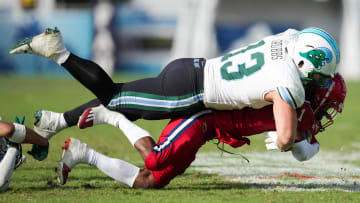 Nov 18, 2023; Boca Raton, Florida, USA;  Tulane Green Wave linebacker Tyler Grubbs (13) tackles Florida Atlantic Owls wide receiver LaJohntay Wester (1) in the second half at FAU Stadium. 