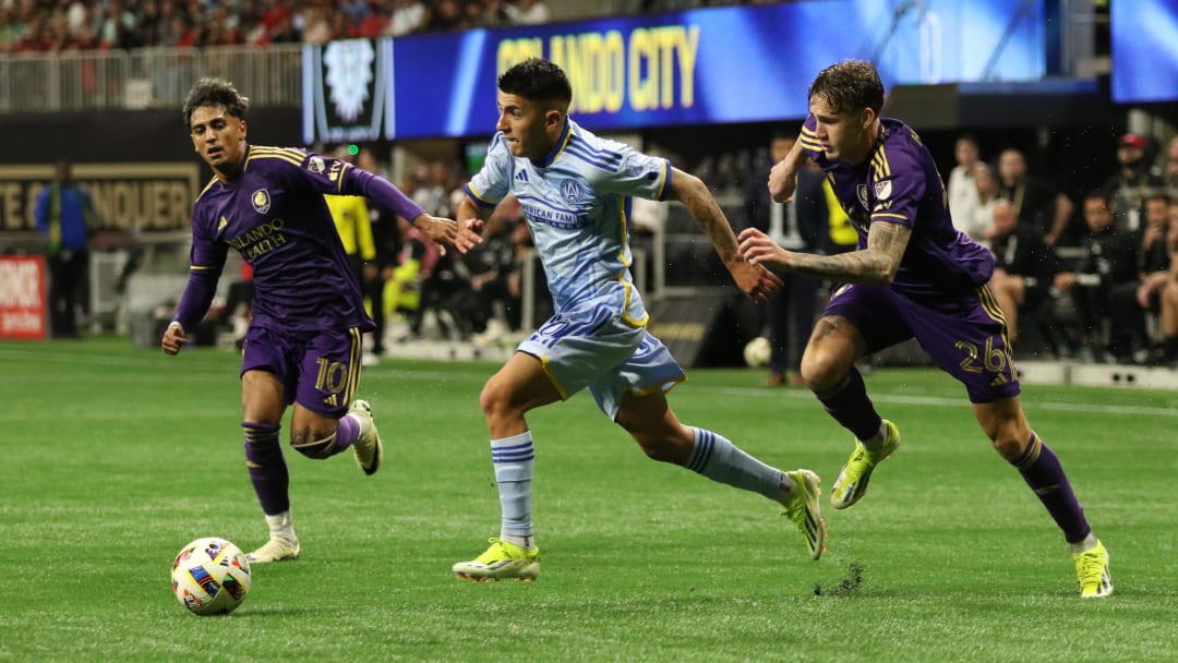 Mar 17, 2024; Atlanta, Georgia, USA;  Atlanta United midfielder Thiago Almada (10) dribbles against Orlando City defender Michael Halliday (26) and midfielder Facundo Torres (10) during the second half at Mercedes-Benz Stadium. Mandatory Credit: Jordan Godfree-USA TODAY Sports